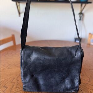 Vintage Black Leather Messenger flap bag. Interior and exterior are leather.